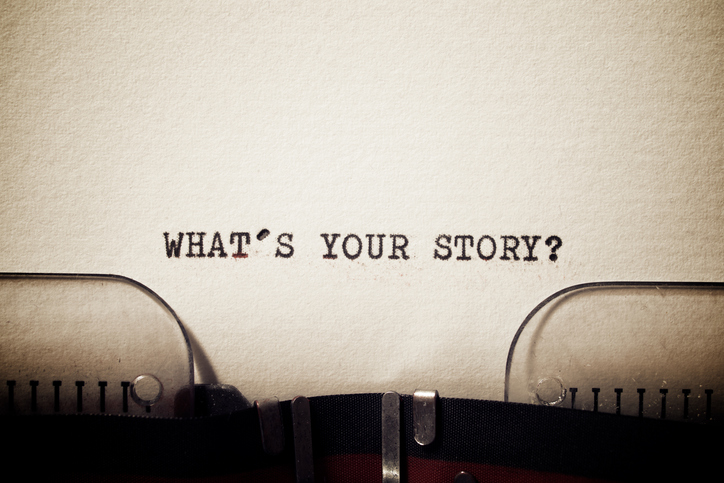 A typewriter with the words What's your Story?