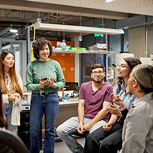 Group of five people in an office having discussions in a circle